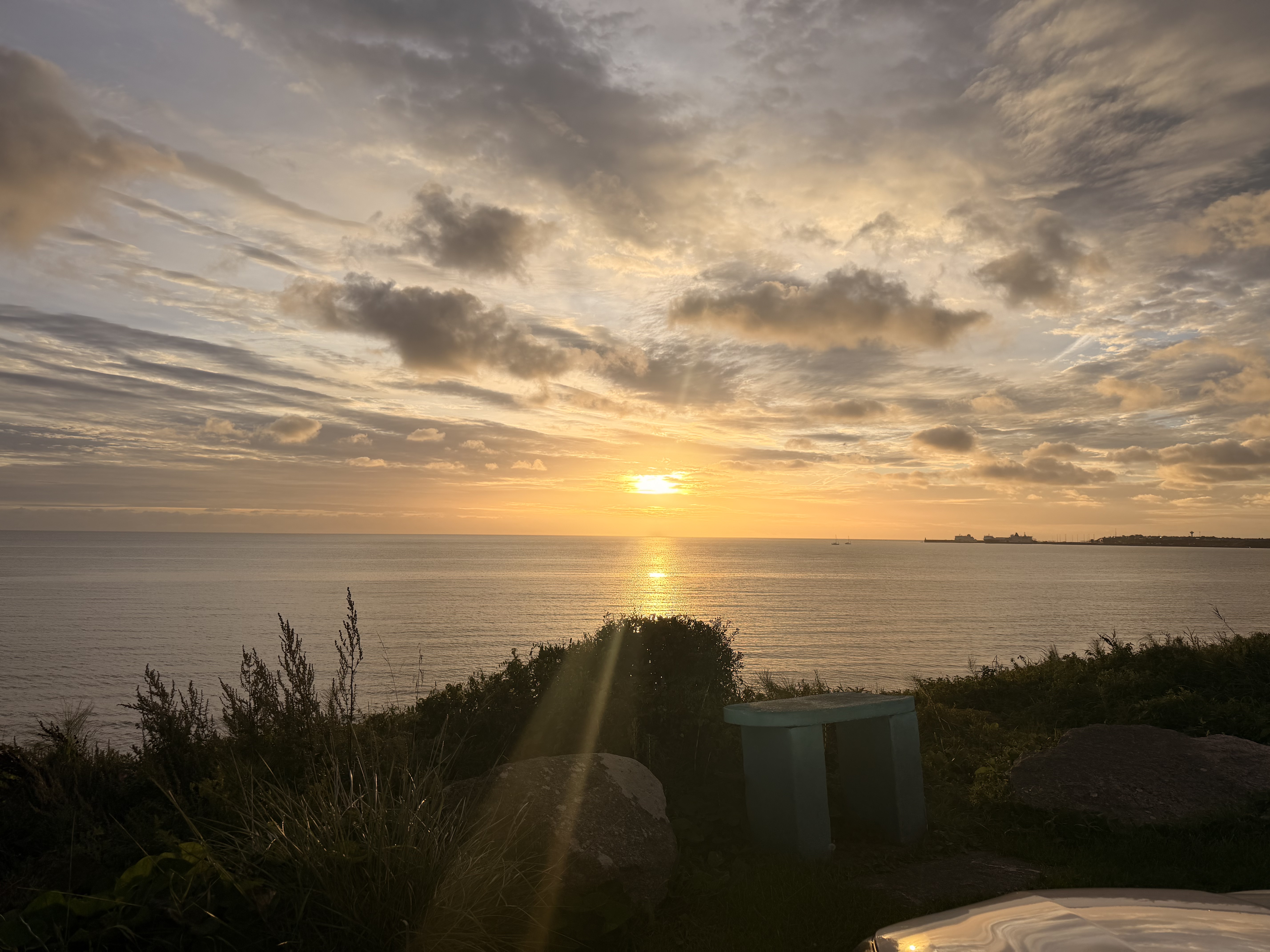 Golden sunset over the sea in the supplied coastal photograph.